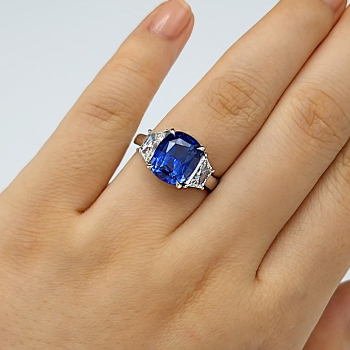 Cushion Cut Sapphire Three Stone Engagement Ring on wedding finger