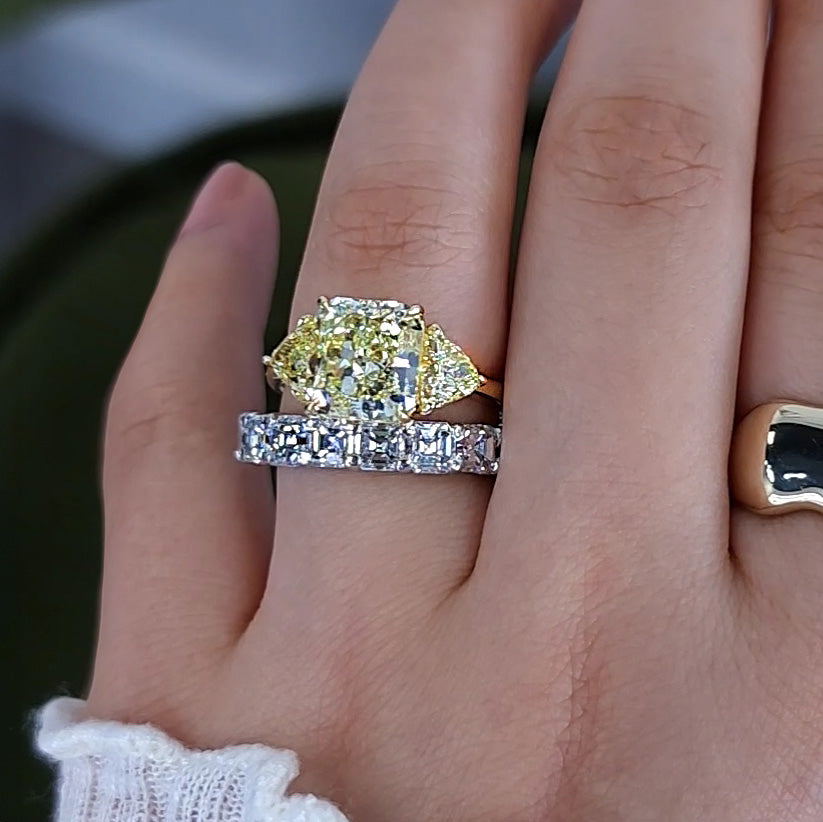 Fancy Yellow Radiant Cut 3 Stone Engagement Ring with Trillions on wedding finger