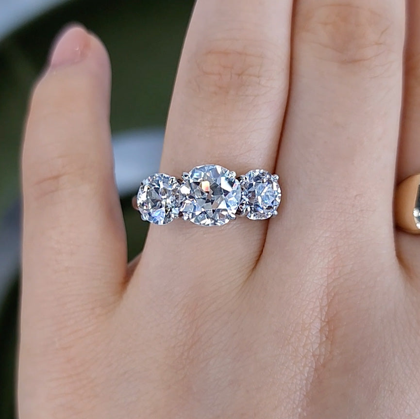 Old European Cut Three Stone Diamond Engagement Ring on wedding finger