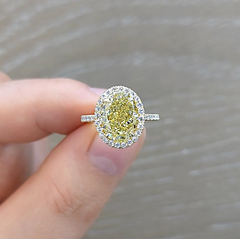 Oval Cut Fancy Yellow Diamond Engagement Ring in a Halo Pave Setting