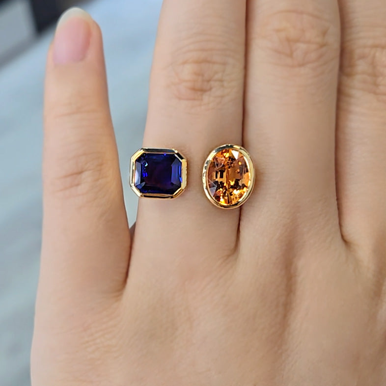 Yellow Gold Bezel Open Toi et Moi Ring, with a Blue Sapphire and Orange Spinel on wedding finger