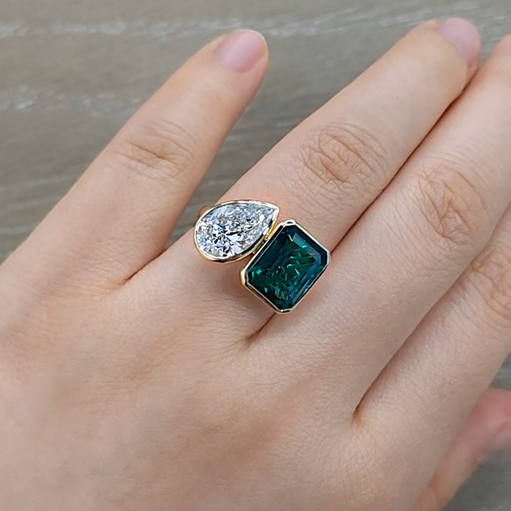 Toi et Moi Ring with Pear Cut Diamond and Green Emerald in Yellow Gold Bezel Setting