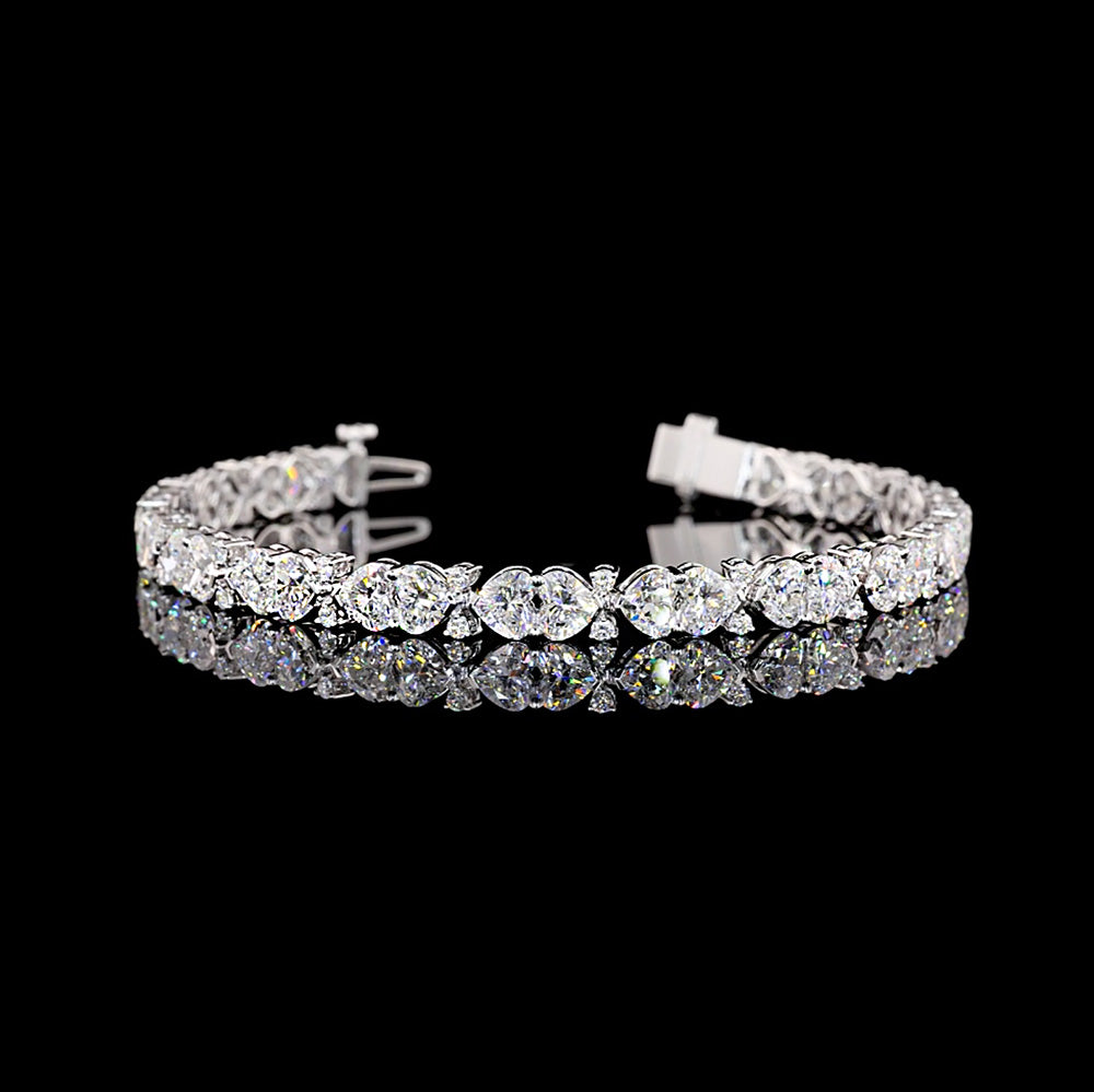 Lab Grown Heart cut diamond tennis bracelet.

12cts total weight, 68 diamonds

E/F VVS-VS1

6.5" long

14K White Gold
