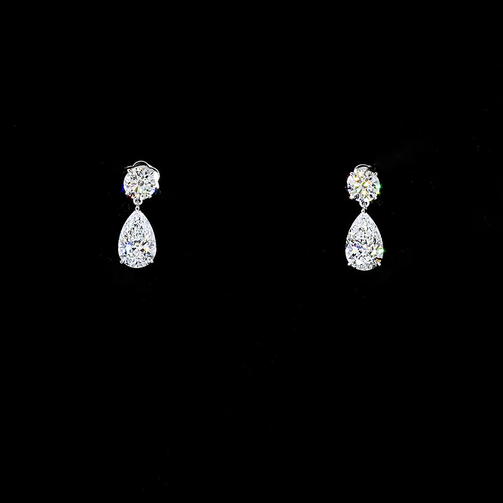 Pear cut and round brilliant cut diamond earrings handcrafted in 14k white gold 5 ct total