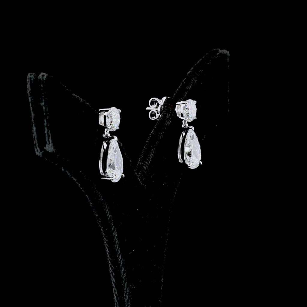 Pear Round Drop Diamond Earrings with both pear and round diamonds set together in 14k white gold setting.